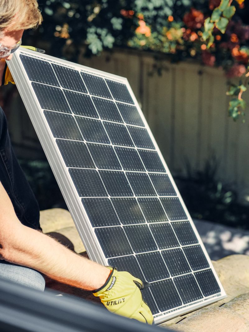 Residential solar panels on tile roof with palm trees