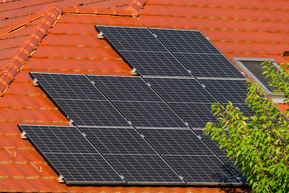 Aerial view of residential suburb with solar panels on rooftops